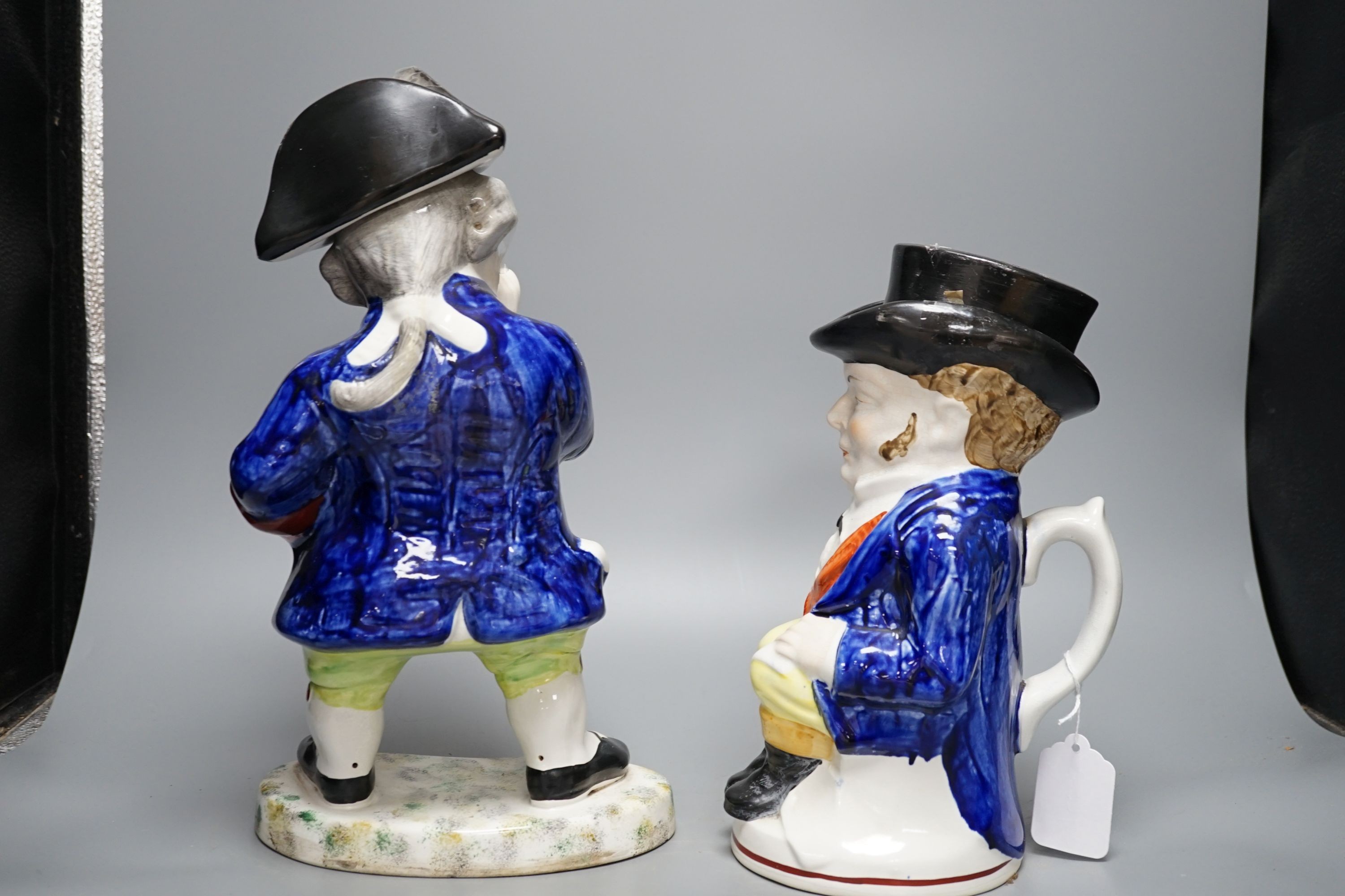 Two Staffordshire Toby jugs and a pair of Kings Charles Spaniel figures